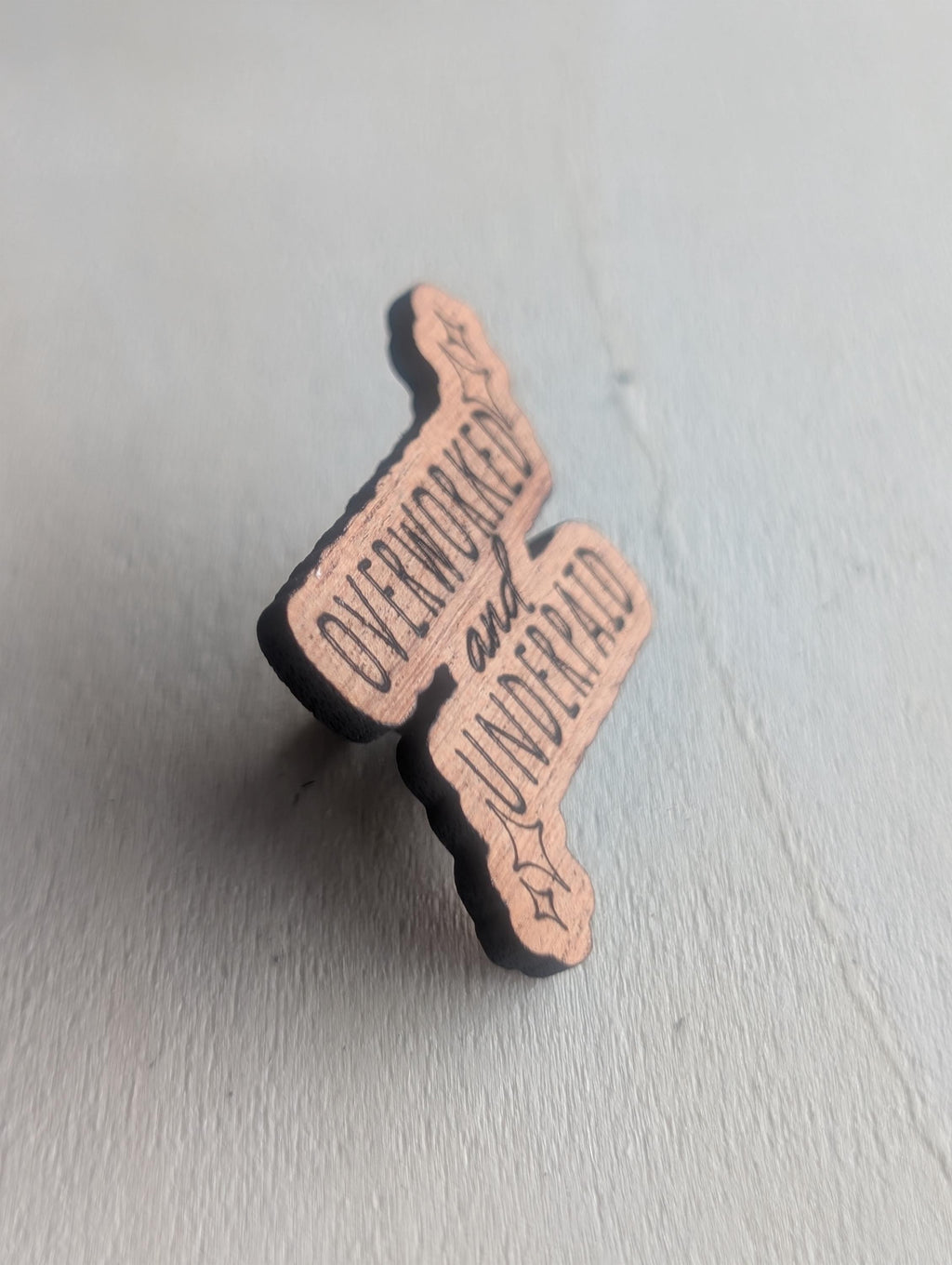 Mahogany overworked and underpaid wooden pin badge, funny badges